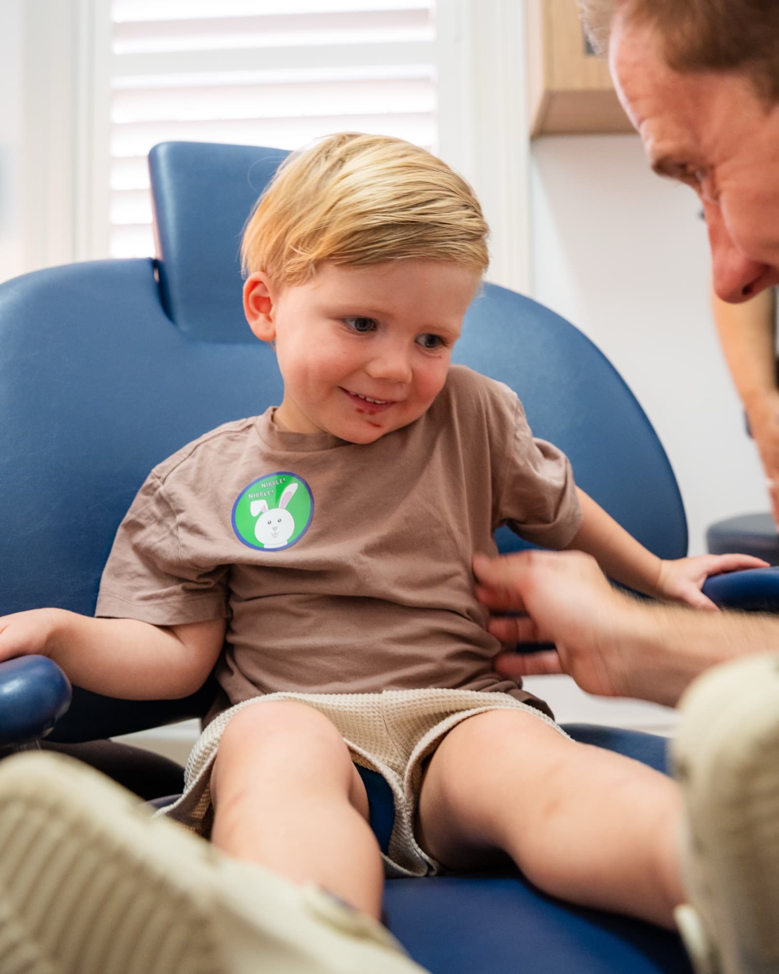 A happy young patient with a sticker, at Dora Street Dental