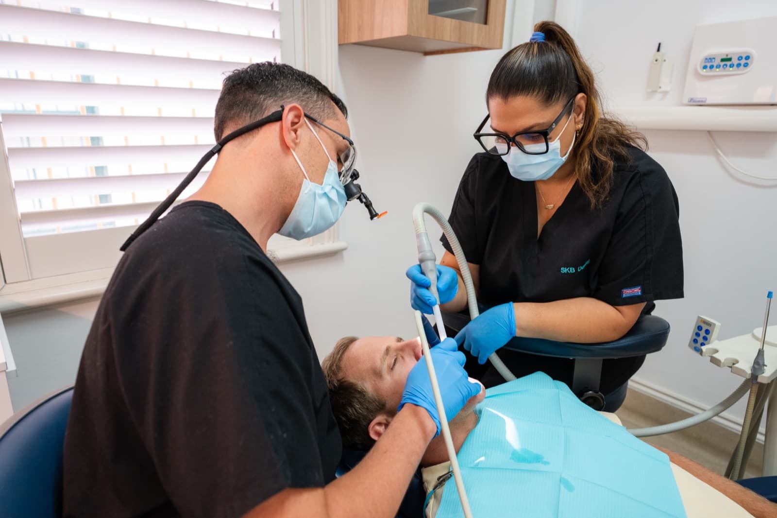 Dr James Bakker working with a dental assistant